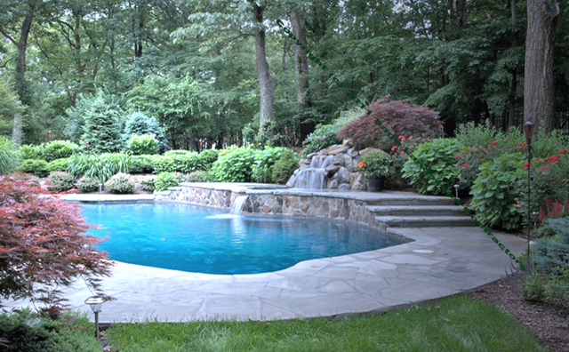 inground pool with waterfalls