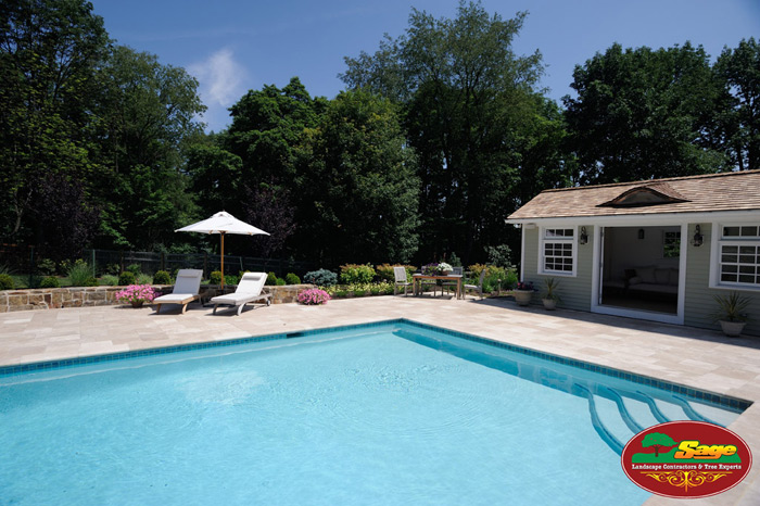 Pool with travertine decking and cabana